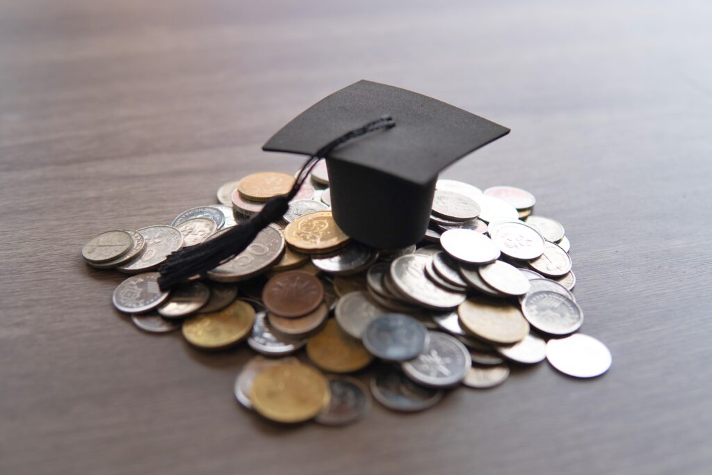 graduation cap on top of a pile of coins 2024 03 14 16 15 40 utc