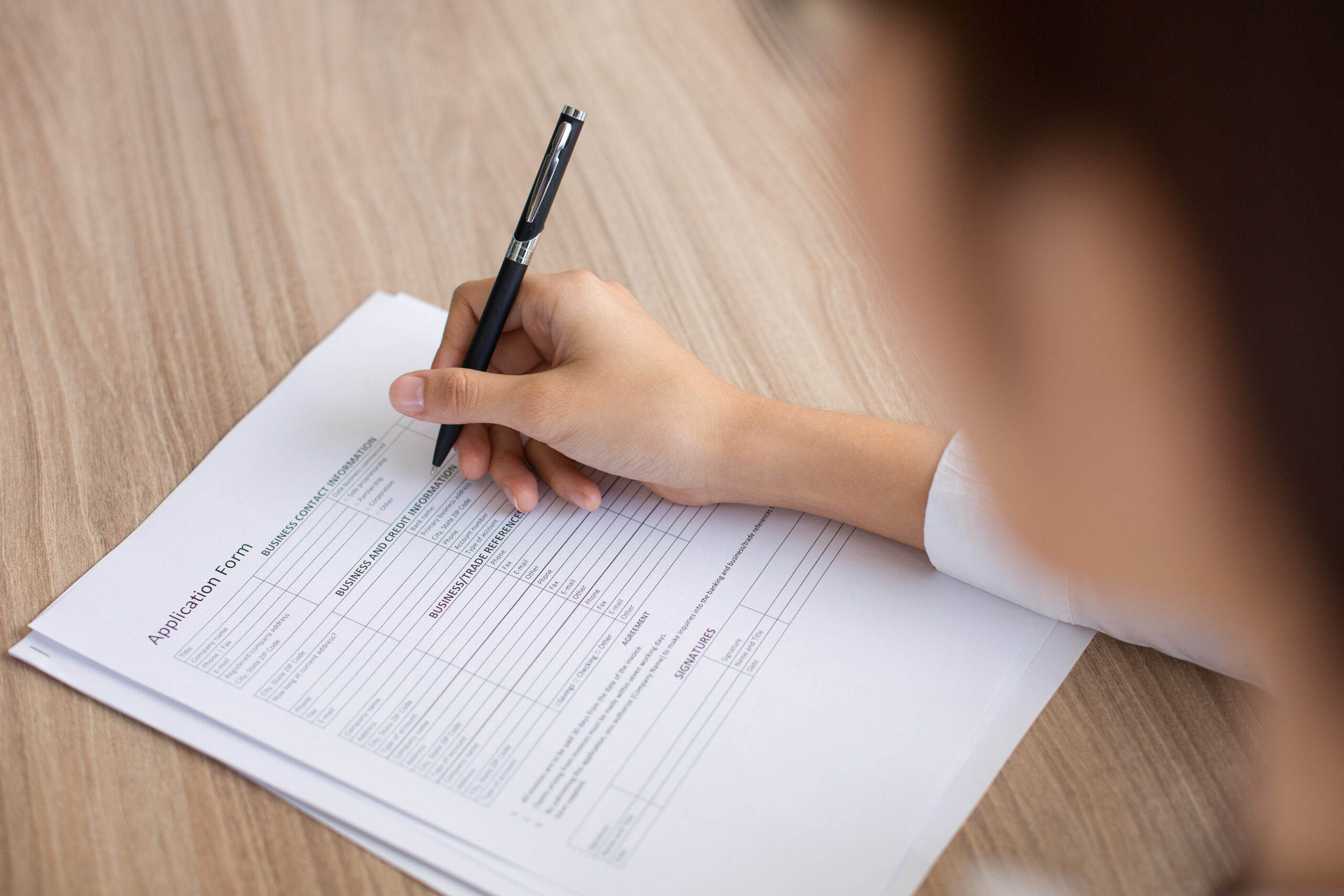 Closeup of Female Applicant Completing Form