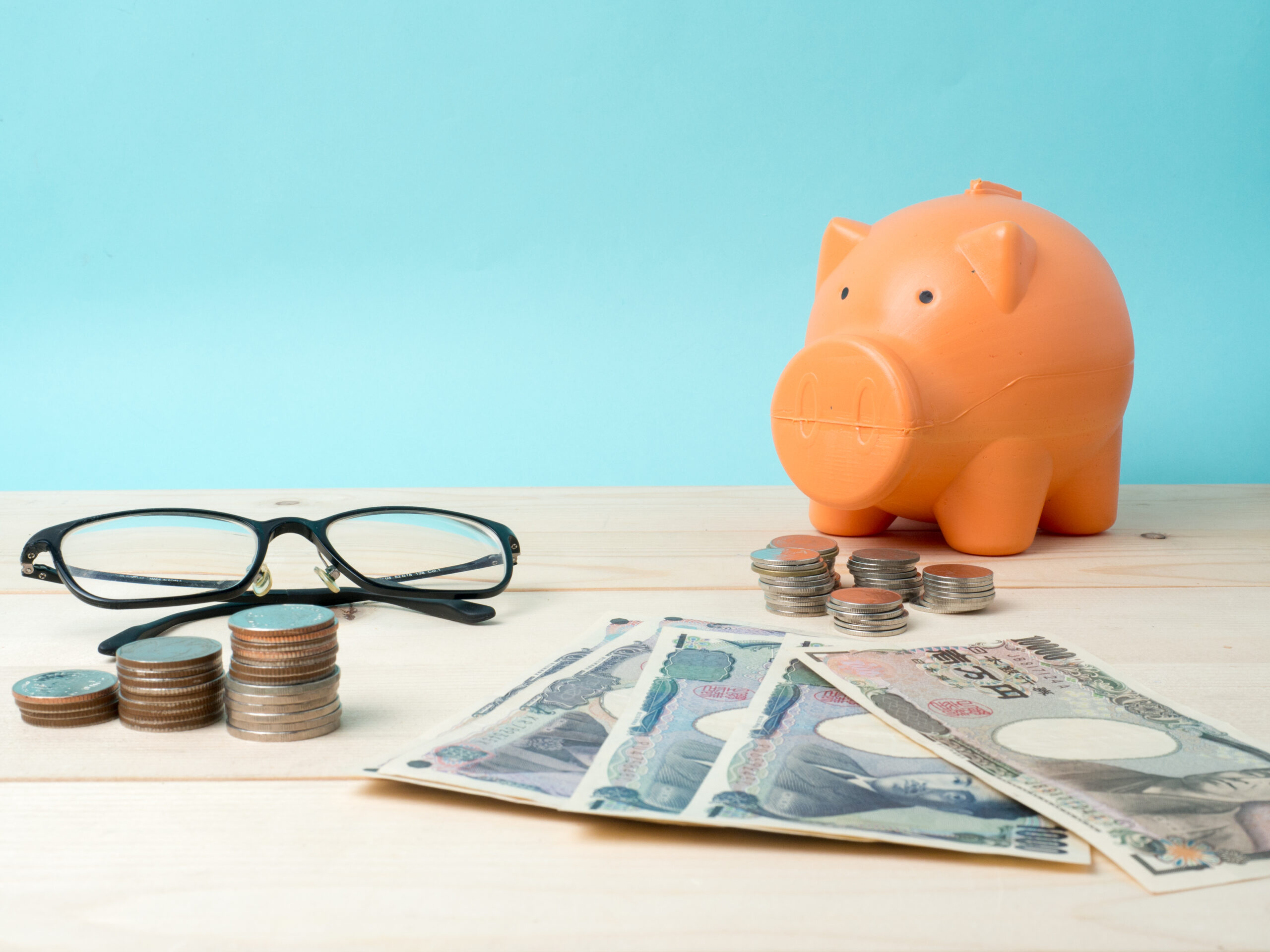 coin stack with house model, savings plans for housing blue back