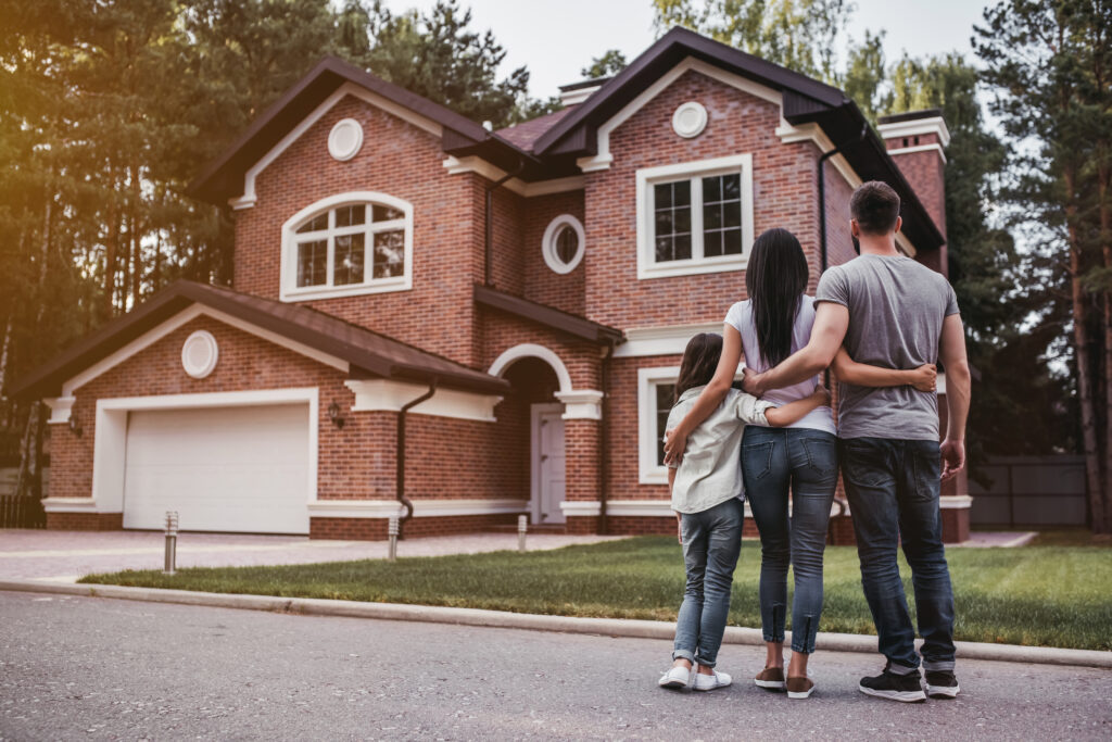Back,View,Of,Happy,Family,Is,Standing,Near,Their,Modern