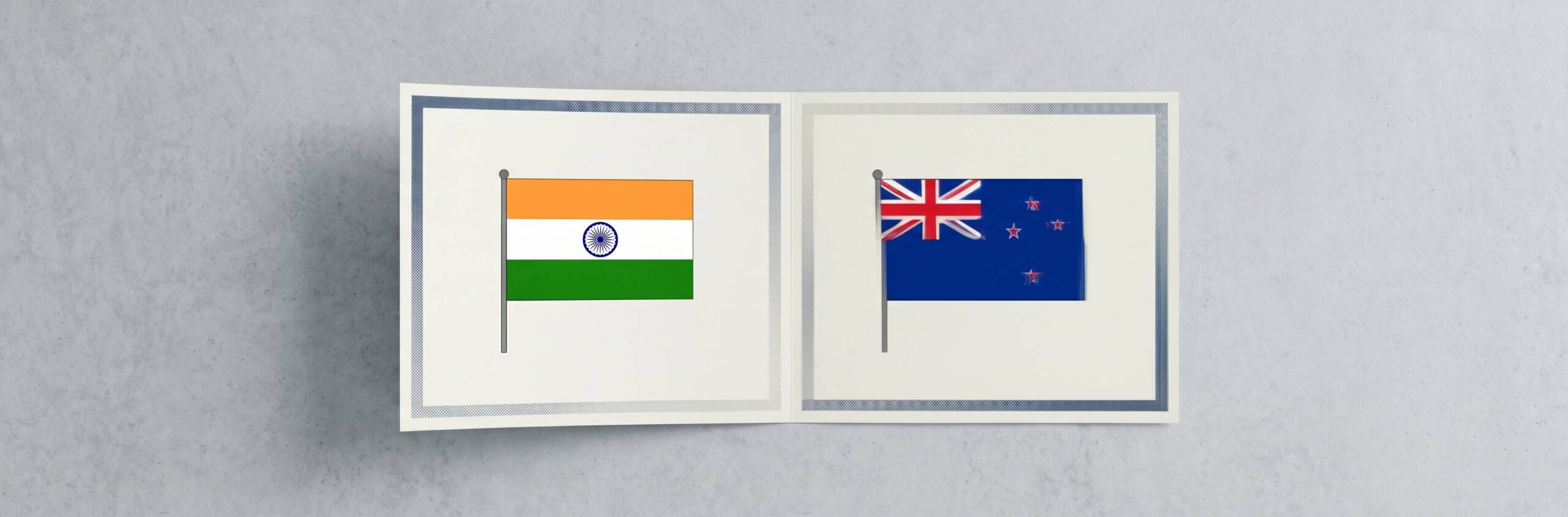 A minimal editorial cover image showing two clean, modern academic certificates placed side by side on a neutral surface, with a subtle seamless overlap or shared edge between them forming a single continuous document, soft natural lighting, neutral tones (white, light grey, soft blue), no text, no flags, no icons, very few elements, ultra-realistic photography style, strong negative space, top-down composition, symbolizing dual degrees and mutual recognition between two countries, cinematic wide. WIth flags of India and New Zealand.